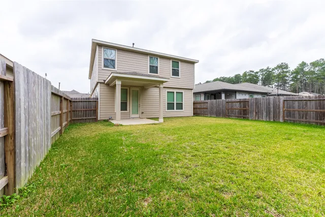 a view of a house with a backyard