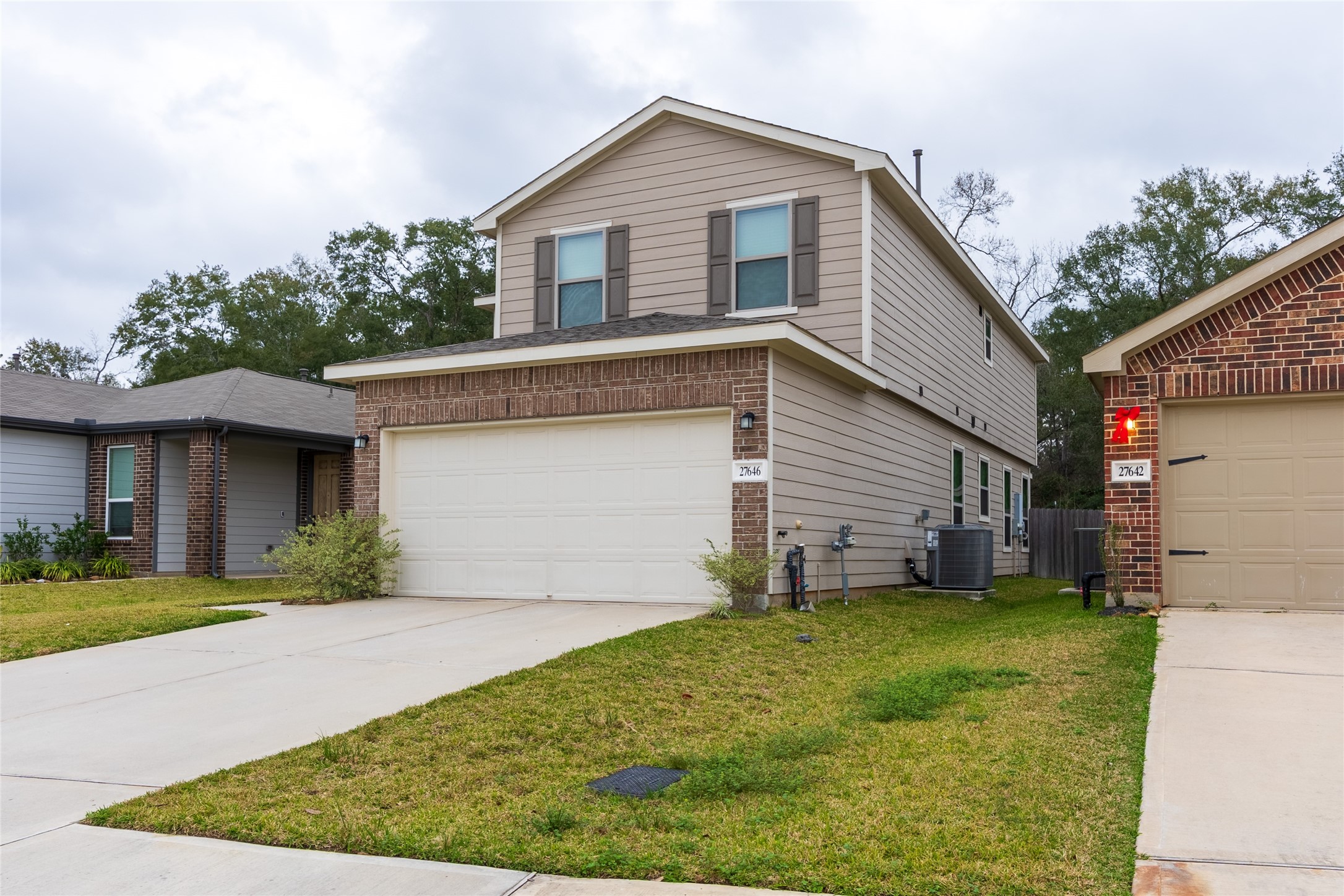 27646 Mesabe Drive Magnolia, TX 77354 - Photo 3 of 24 a front view of a house with a yard and garage