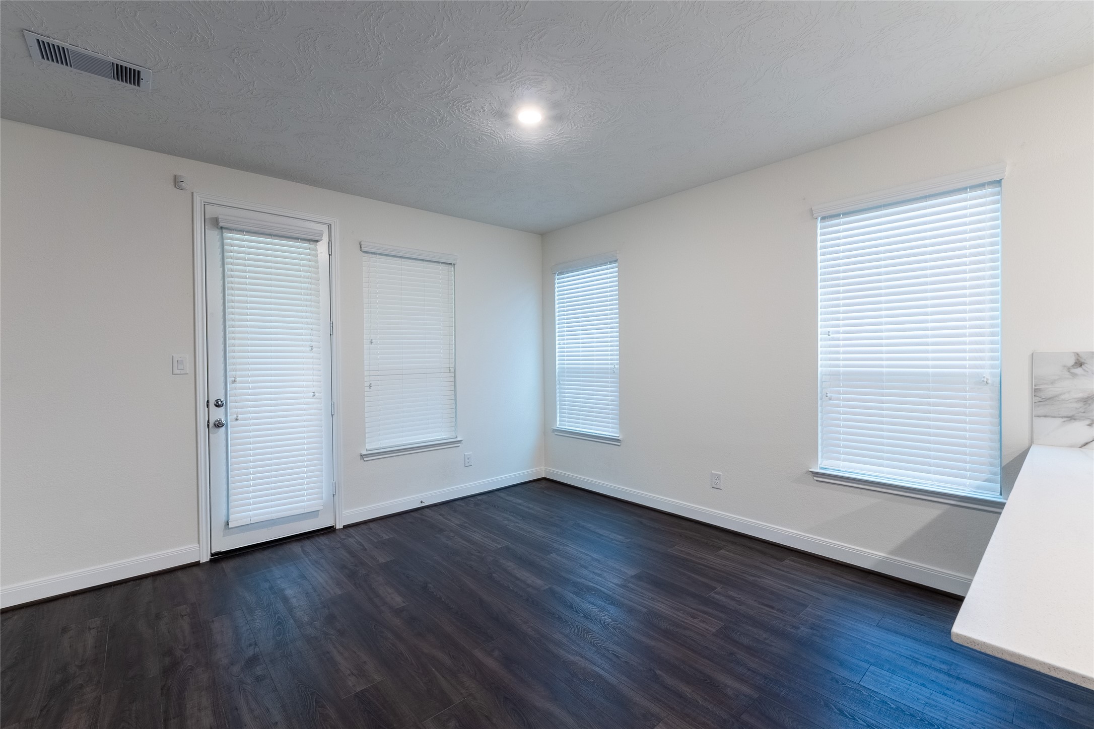 27646 Mesabe Drive Magnolia, TX 77354 - Photo 8 of 24 an empty room with wooden floor and windows