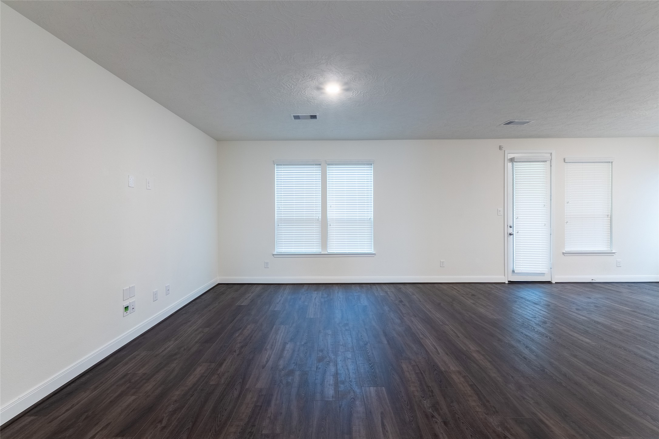27646 Mesabe Drive Magnolia, TX 77354 - Photo 10 of 24 an empty room with wooden floor and windows