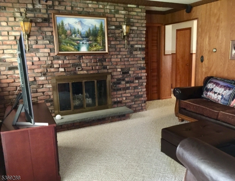 15 Luff Road Boonton, NJ 07005 - Photo 12 of 43 a living room with furniture a flat screen tv and a fireplace
