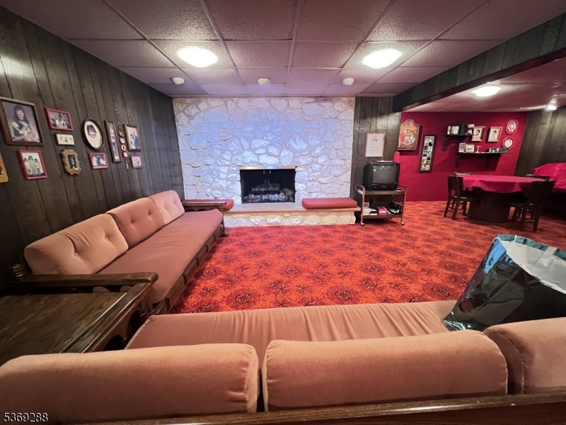 15 Luff Road Boonton, NJ 07005 - Photo 32 of 43 a living room with furniture a flat screen tv and a fireplace