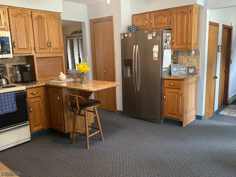15 Luff Road Boonton, NJ 07005 - Photo 5 of 43 a kitchen with stainless steel appliances granite countertop a refrigerator a sink dishwasher and wooden cabinets with wooden floor