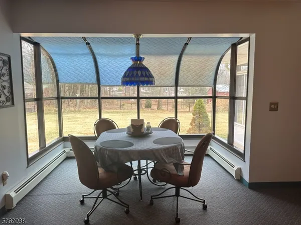 a view of a dining room with furniture and a window