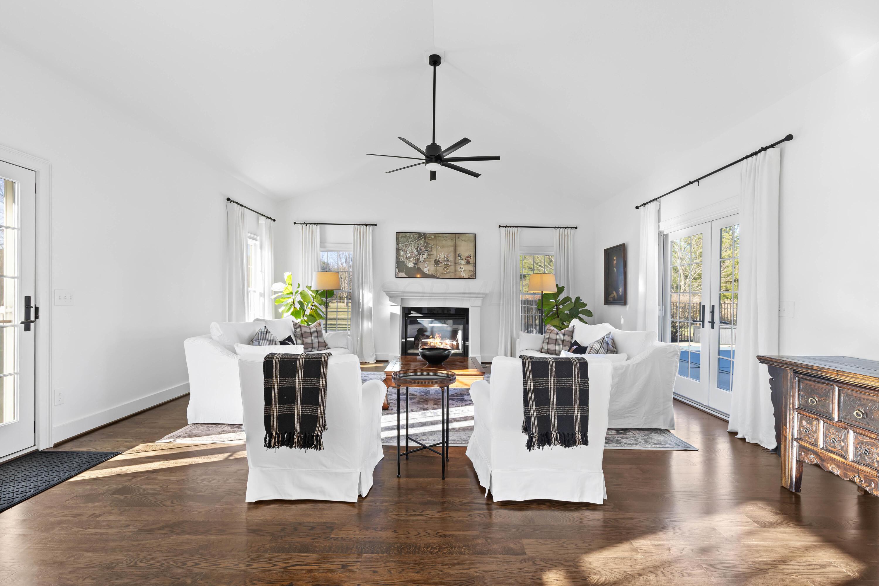 1364 Dale Ford Road Delaware, OH 43015 - Photo 36 of 112 • Hardwood flooring • White painted walls • Cathedral ceiling • Lighted ceiling fan • Gas fireplace with mantle (vented out) • Atrium door to side covered porch • French doors to pool patio • Drapes remain