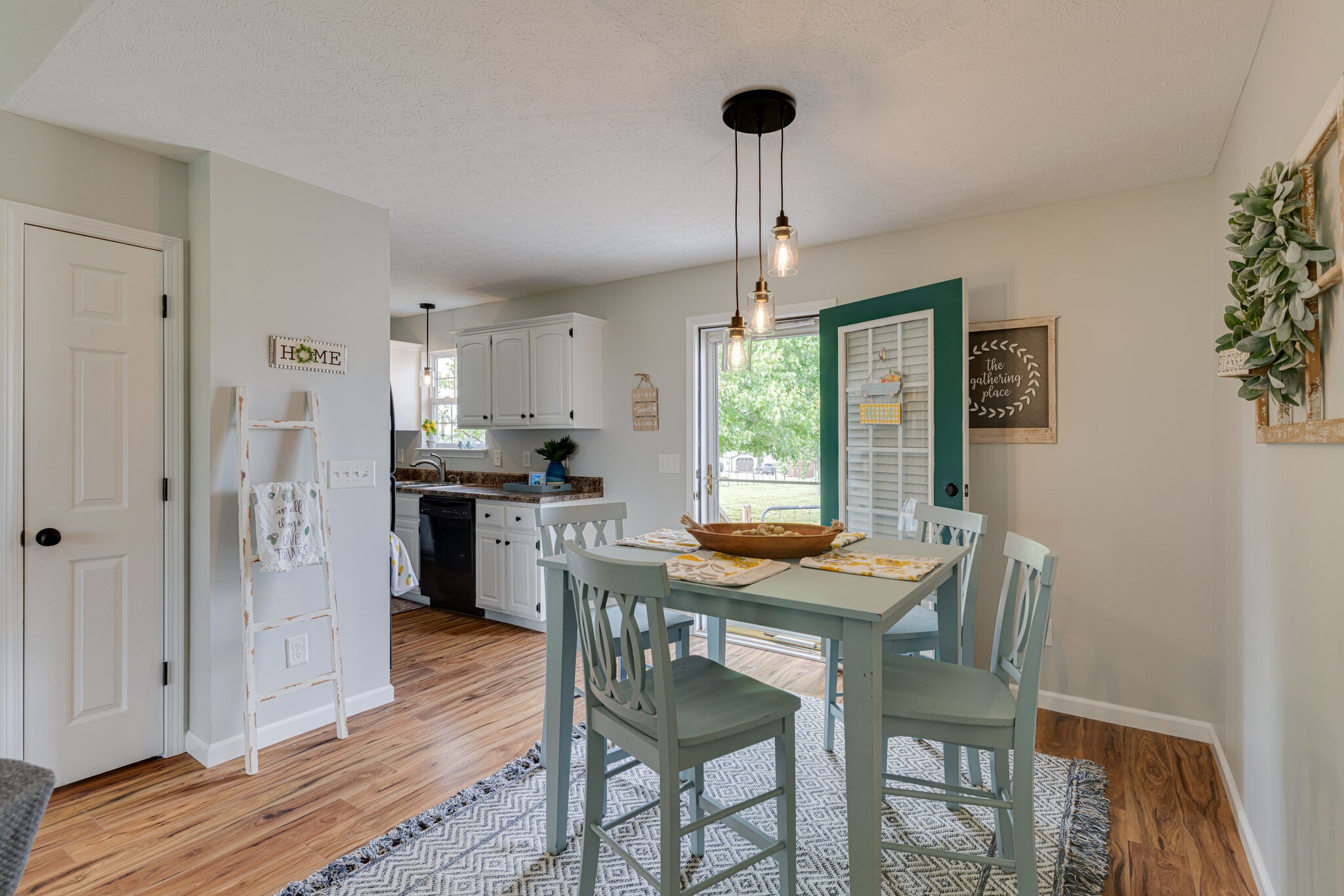 220 Old Martin Chapel Road Portland, TN 37148 - Photo 7 of 31 a kitchen with stainless steel appliances wooden floor dining table and chairs