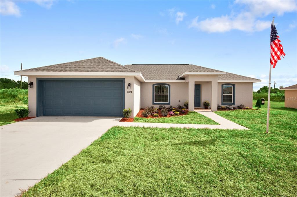 14284 Southwest 78th Terrace Ocala, FL 34473 - Photo 1 of 1 a front view of a house with a yard and garage
