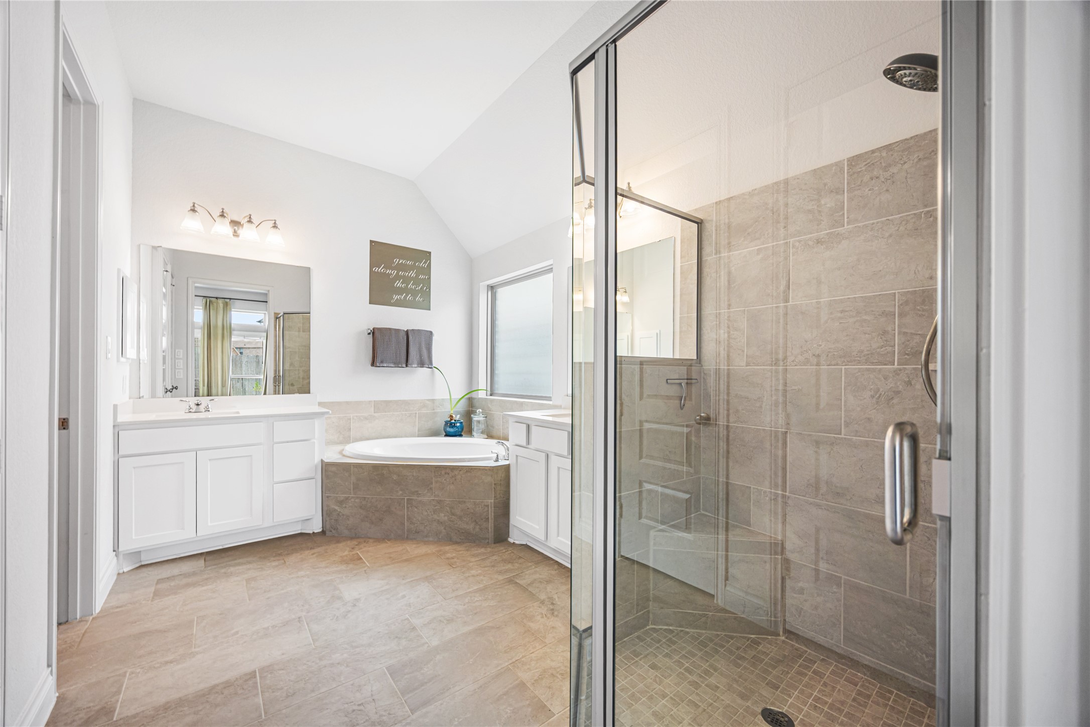 28169 Knight Peak Drive Spring, TX 77386 - Photo 15 of 33 a bathroom with a tub sink shower and mirror