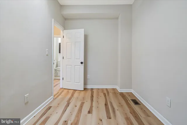 a view of a room with wooden floor and bench