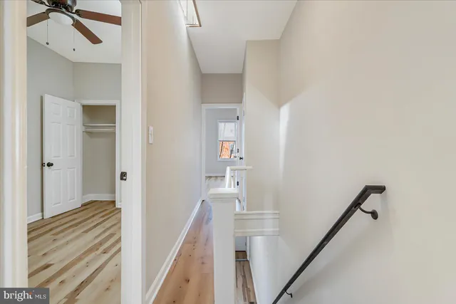 a view of a hallway with a white walls and stairs