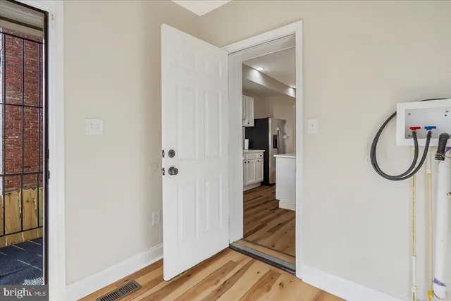 a view of room with wooden floor