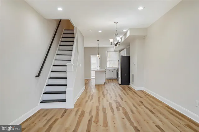 en view of a room with wooden floor and stairs