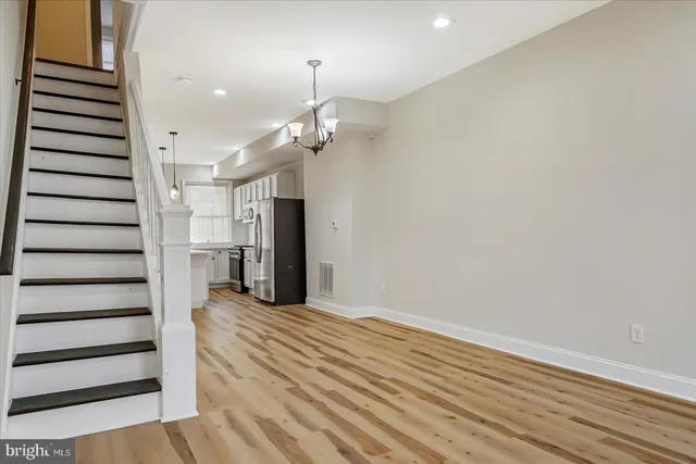 an empty room with wooden floor