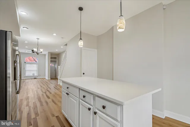 a view of a room with wooden floor and windows