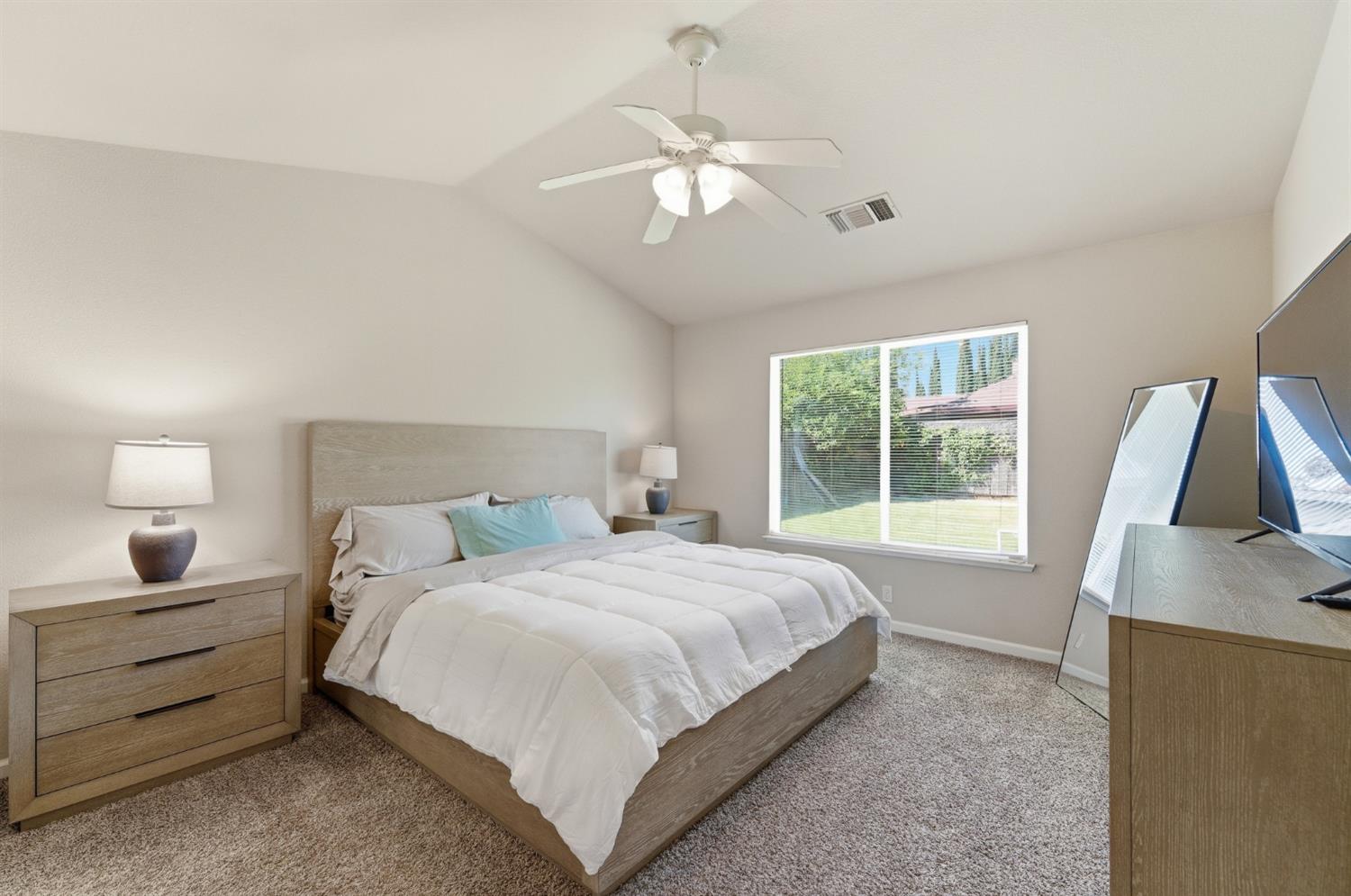 1933 Lifetime Drive Modesto, CA 95355 - Photo 20 of 38 a bedroom with a bed and a flat tv screen on dresser