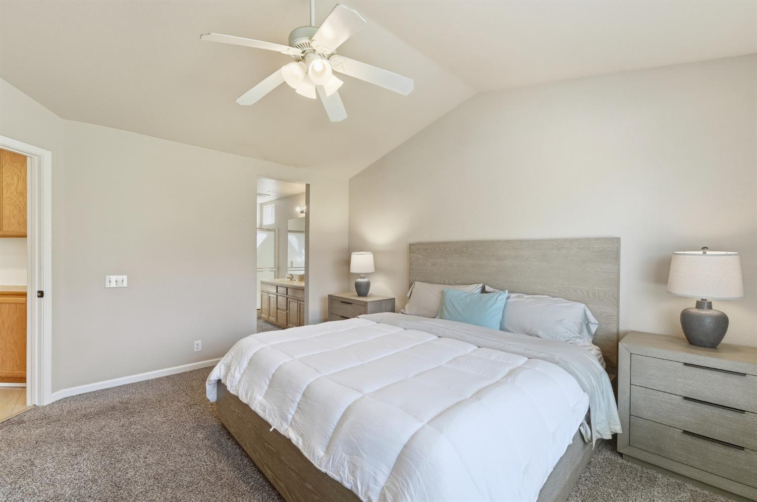 1933 Lifetime Drive Modesto, CA 95355 - Photo 21 of 38 a bedroom with a bed and a chandelier