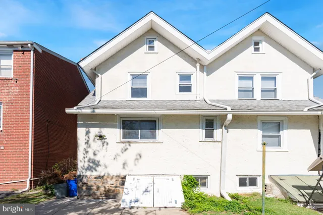 a view of a white building with large windows