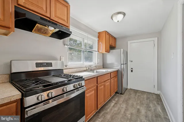 a kitchen with stainless steel appliances granite countertop a stove and a refrigerator