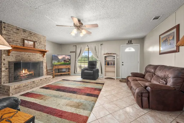 a bathroom with a granite countertop sink toilet and mirror