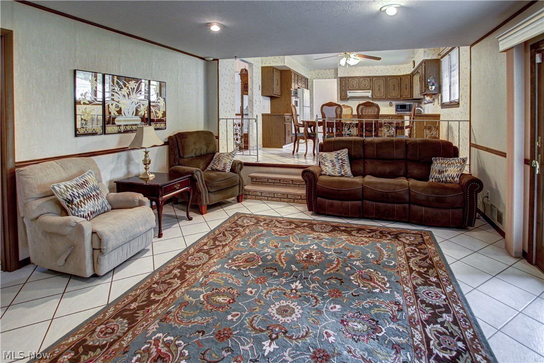 6013 Rousseau Drive Parma, OH 44129 - Photo 8 of 50 Family room with plenty of natural light, ceiling fan, and light tile floors