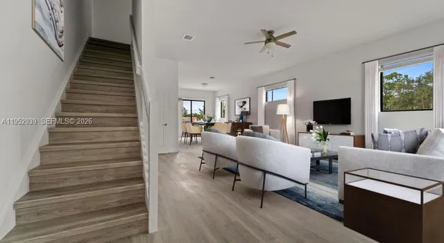 a living room with furniture and a flat screen tv