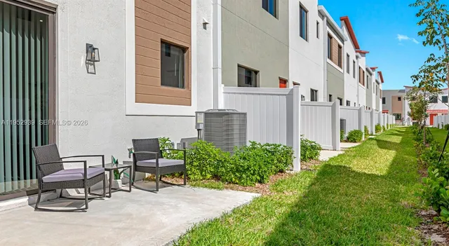 a view of two chairs in a backyard