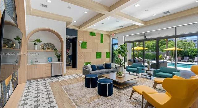 a living room with patio furniture and a large window