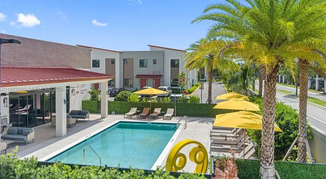 a swimming pool with outdoor seating and yard