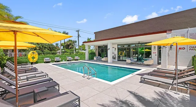 a view of a patio with a table and chairs under an umbrella
