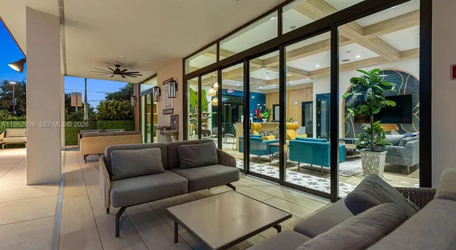 a living room with furniture and a floor to ceiling window