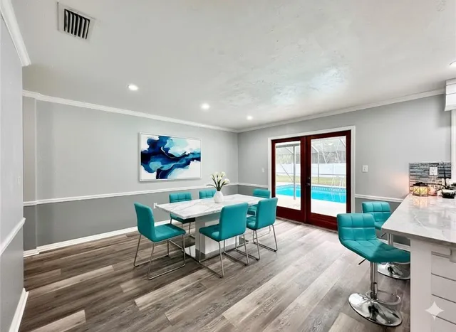 a living room with furniture a window and wooden floor
