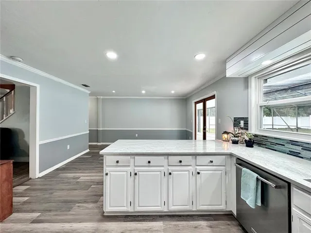 a kitchen with stainless steel appliances granite countertop a sink and a stove