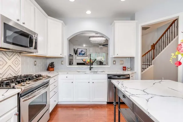 a kitchen with a stove a sink and a microwave