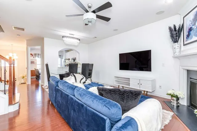 a living room with furniture and a dining table