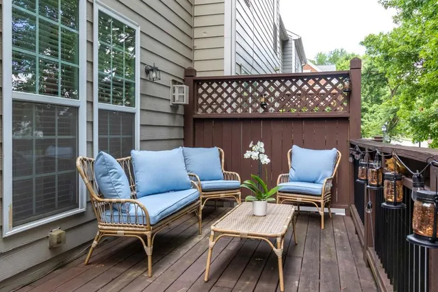a view of a deck with table and chairs and wooden floor