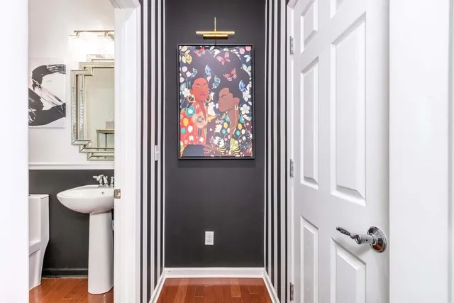 a bathroom with a toilet sink and mirror