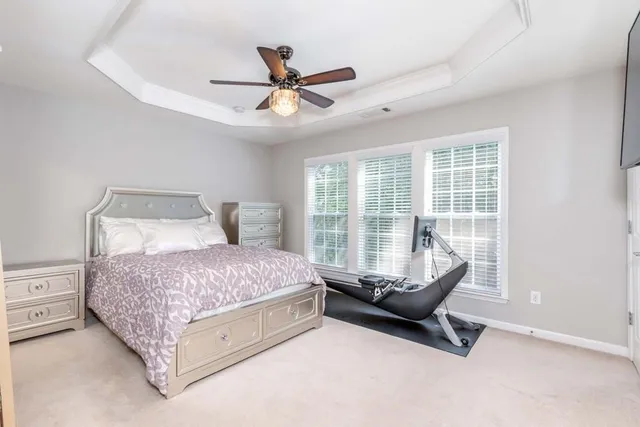 a bedroom with a bed and a ceiling fan