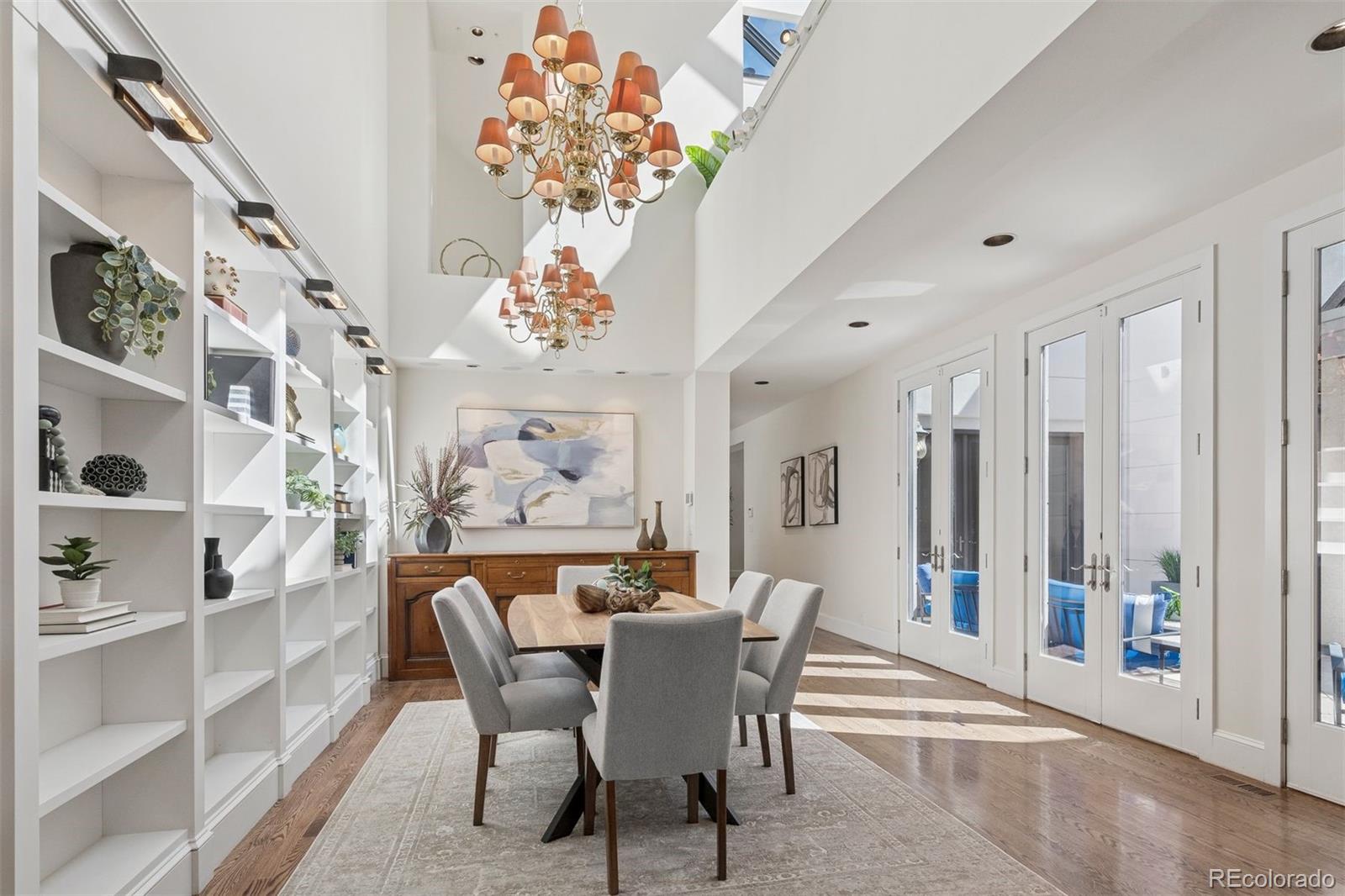 375 Clayton Street Denver, CO 80206 - Photo 14 of 45 a dining room with furniture a chandelier and a rug