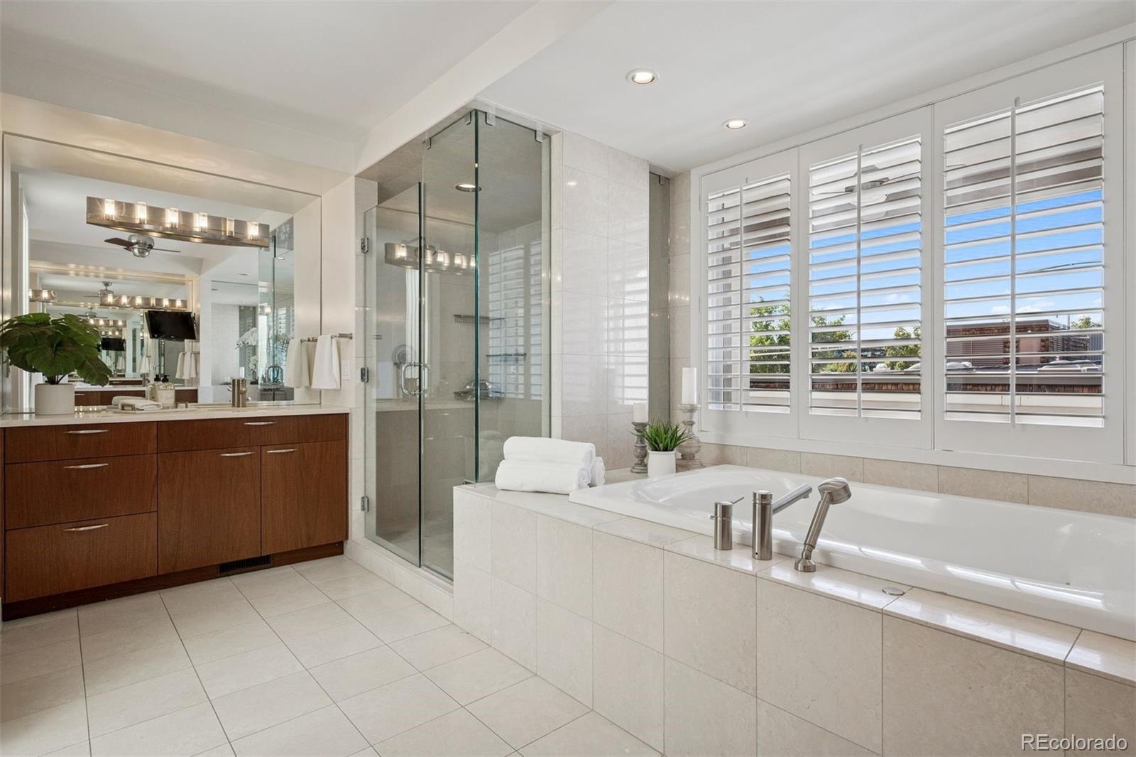 375 Clayton Street Denver, CO 80206 - Photo 29 of 45 a spacious bathroom with a large tub shower and sink