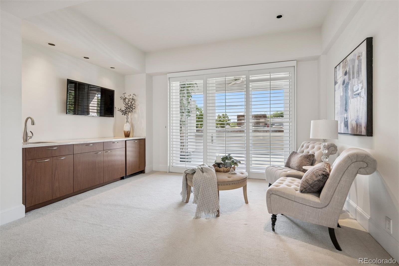 375 Clayton Street Denver, CO 80206 - Photo 32 of 45 a living room with furniture and a flat screen tv