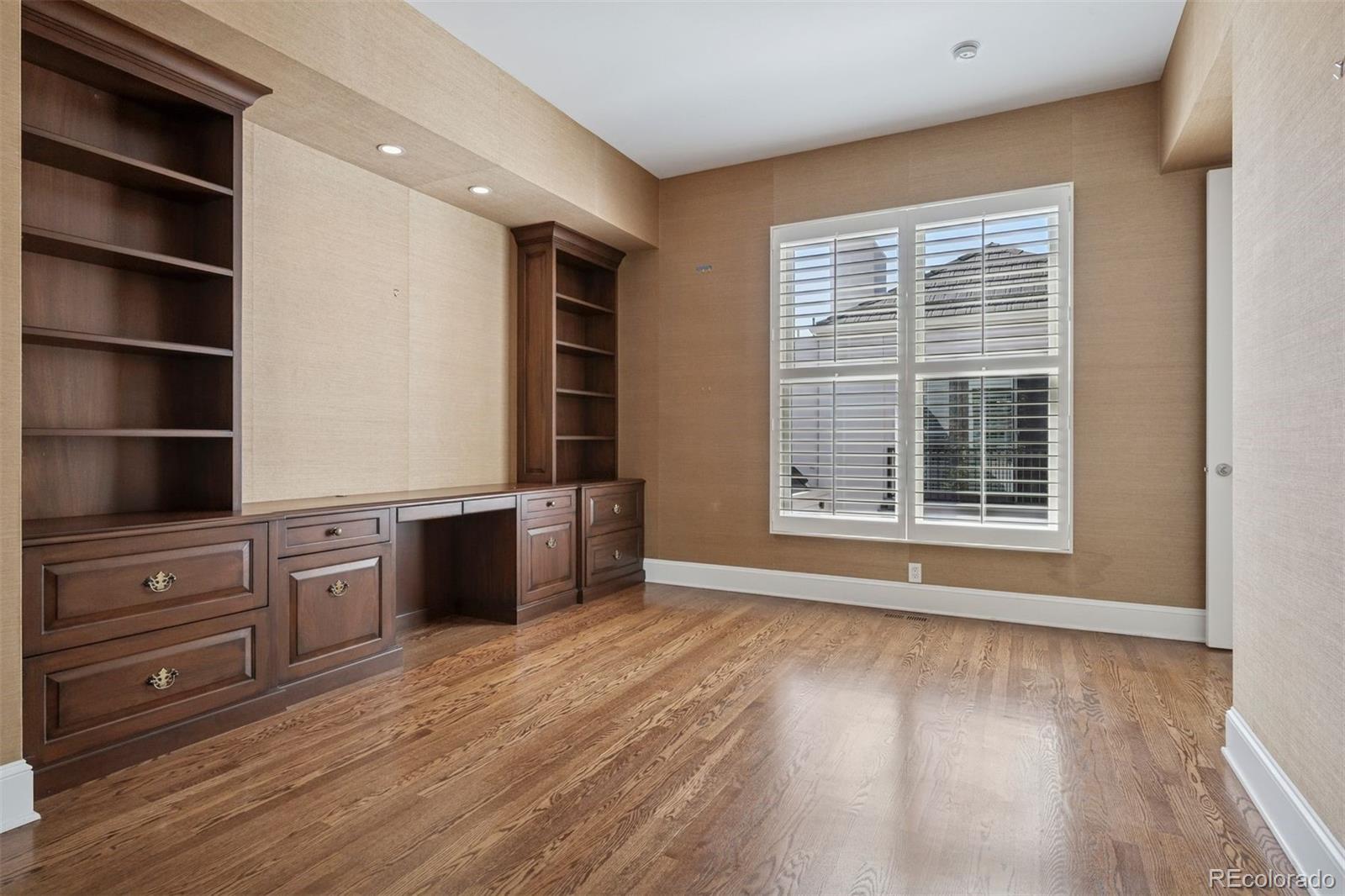 375 Clayton Street Denver, CO 80206 - Photo 33 of 45 a view of an empty room with a window and wooden floor