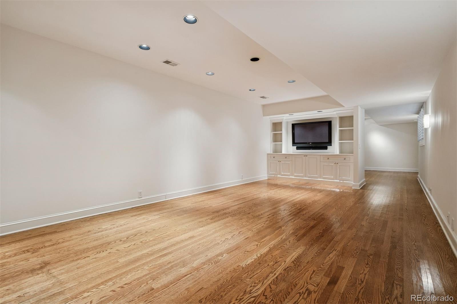 375 Clayton Street Denver, CO 80206 - Photo 34 of 45 a view of an empty room with wooden floor