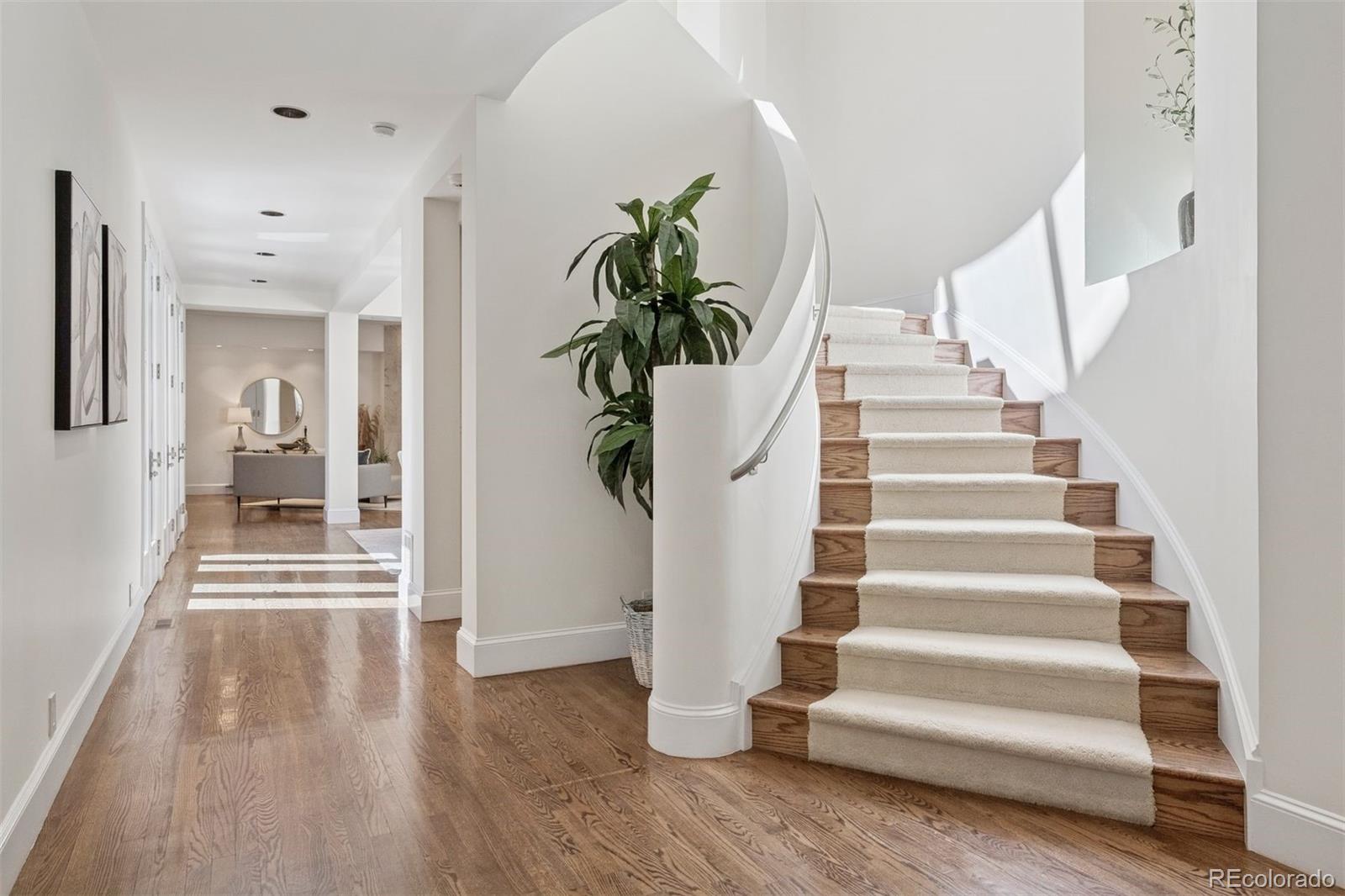 375 Clayton Street Denver, CO 80206 - Photo 4 of 45 a view of entryway with wooden floor and stairs