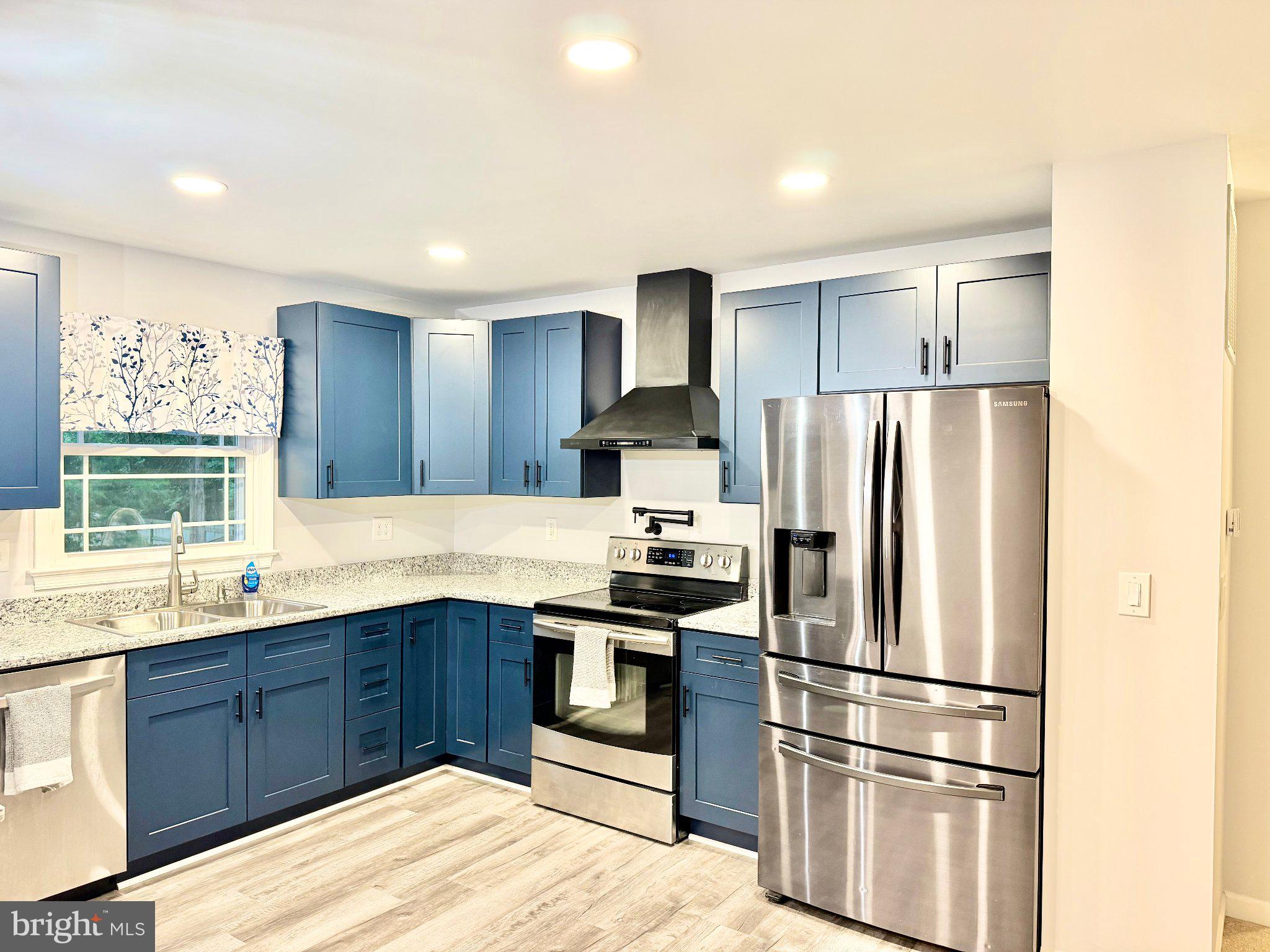 2175 Sebastian Road Fredericksburg, VA 22405 - Photo 15 of 37 Modern kitchen with blue cabinetry.