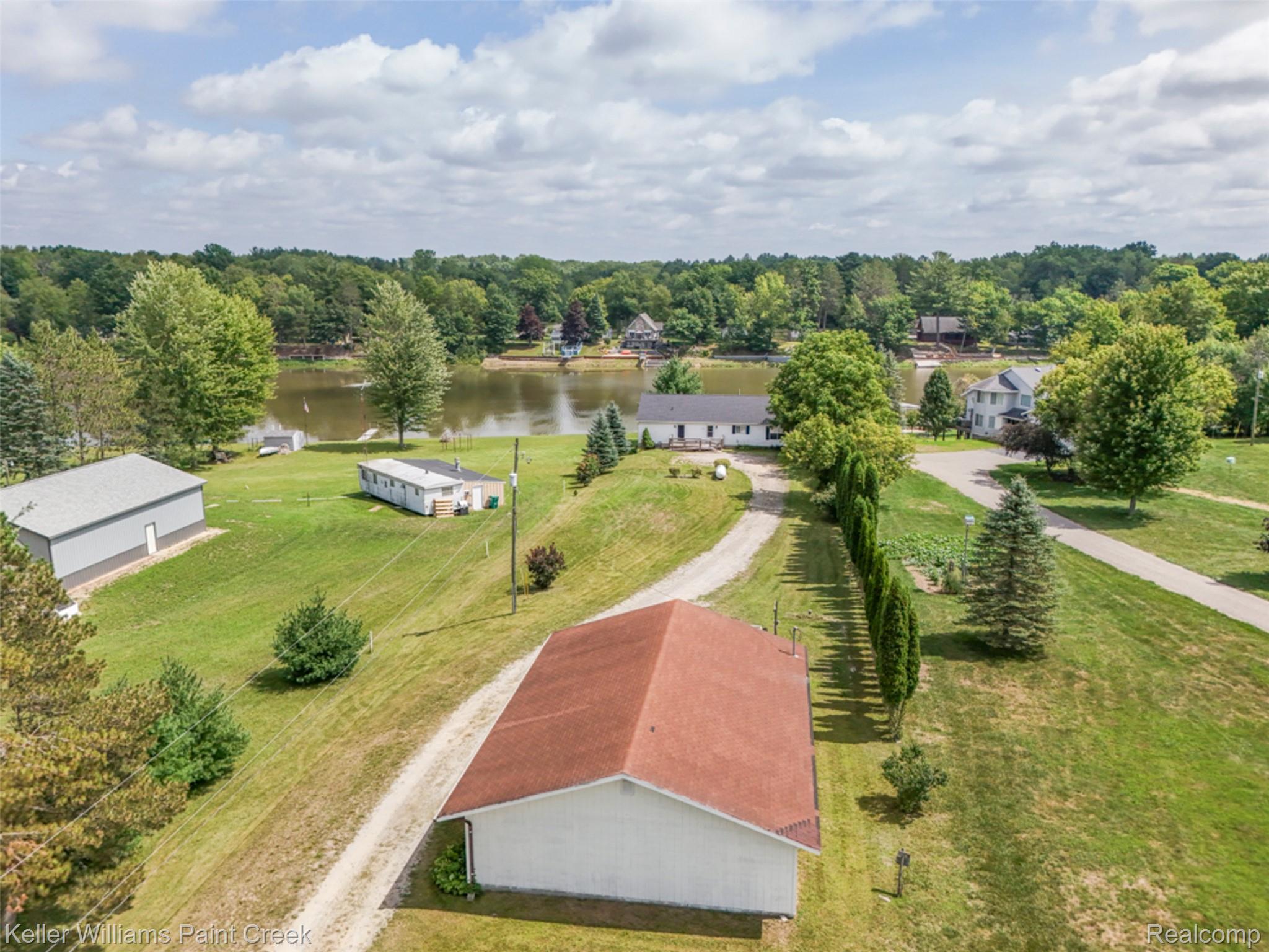 533 White Road Gladwin, MI 48624 - Photo 67 of 69 Expansive property featuring waterfront access, a long gravel drive, mature perimeter trees, and a detached outbuilding