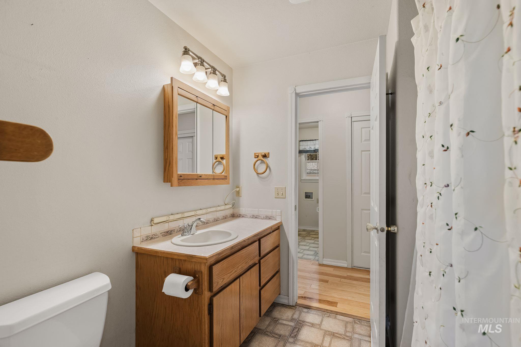 1820 Winchester Road Winchester, ID 83555 - Photo 21 of 50 Wood-finish vanity with a drop-in sink and brushed nickel faucet