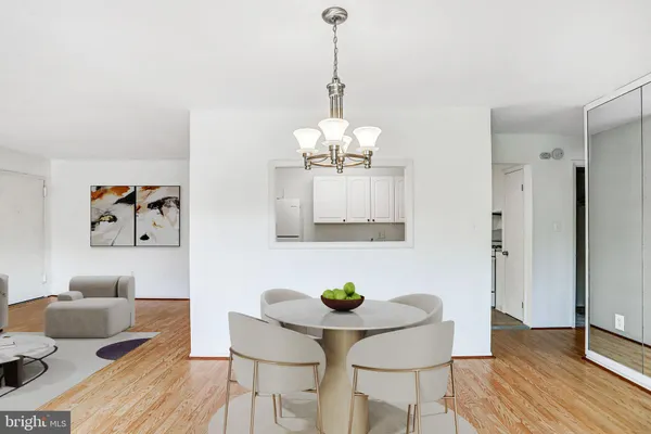 a dining room with furniture and wooden floor