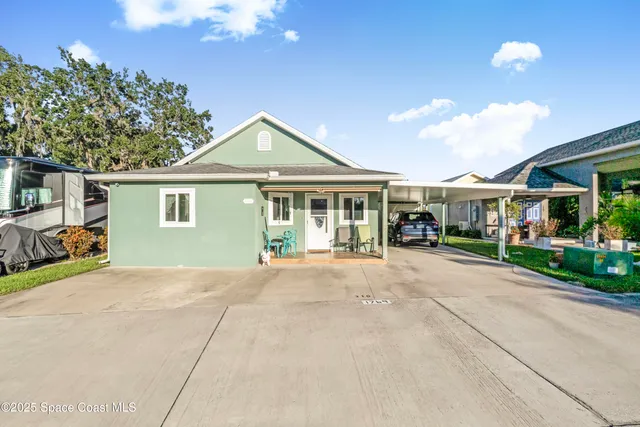 a view of a house with a garden and pathway