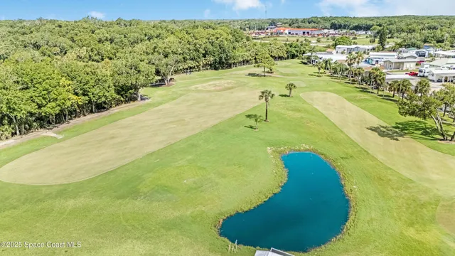 a green field with view of the tall building