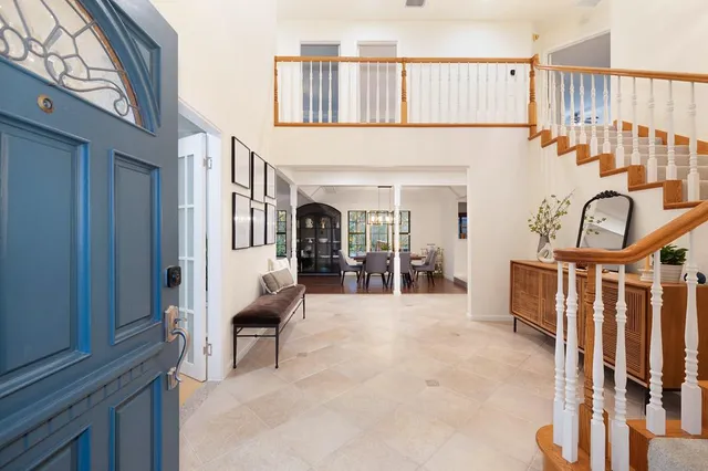 a view of living room kitchen and entryway